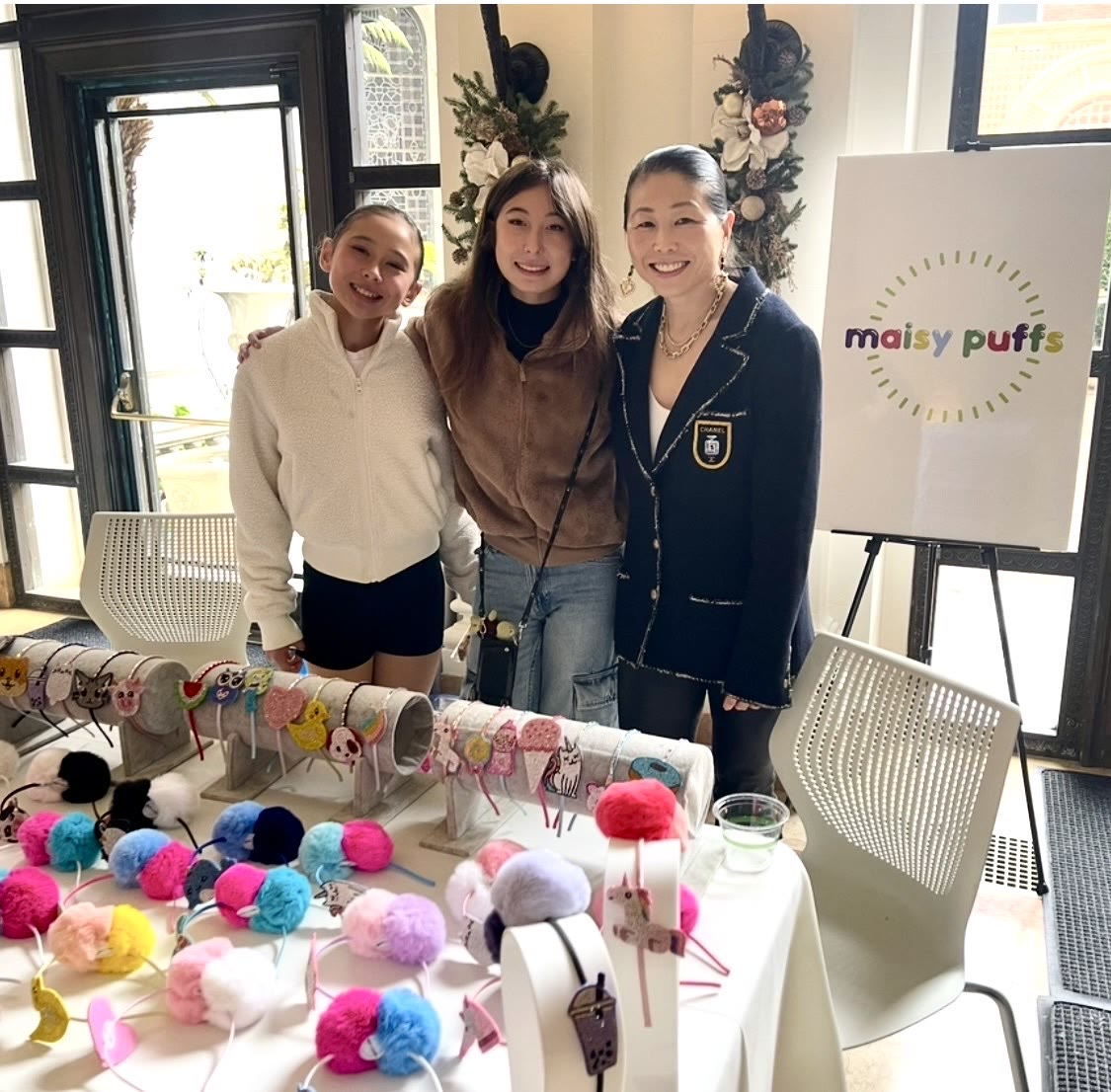 Dr. Shen Garnett with her daughters at their community market stall