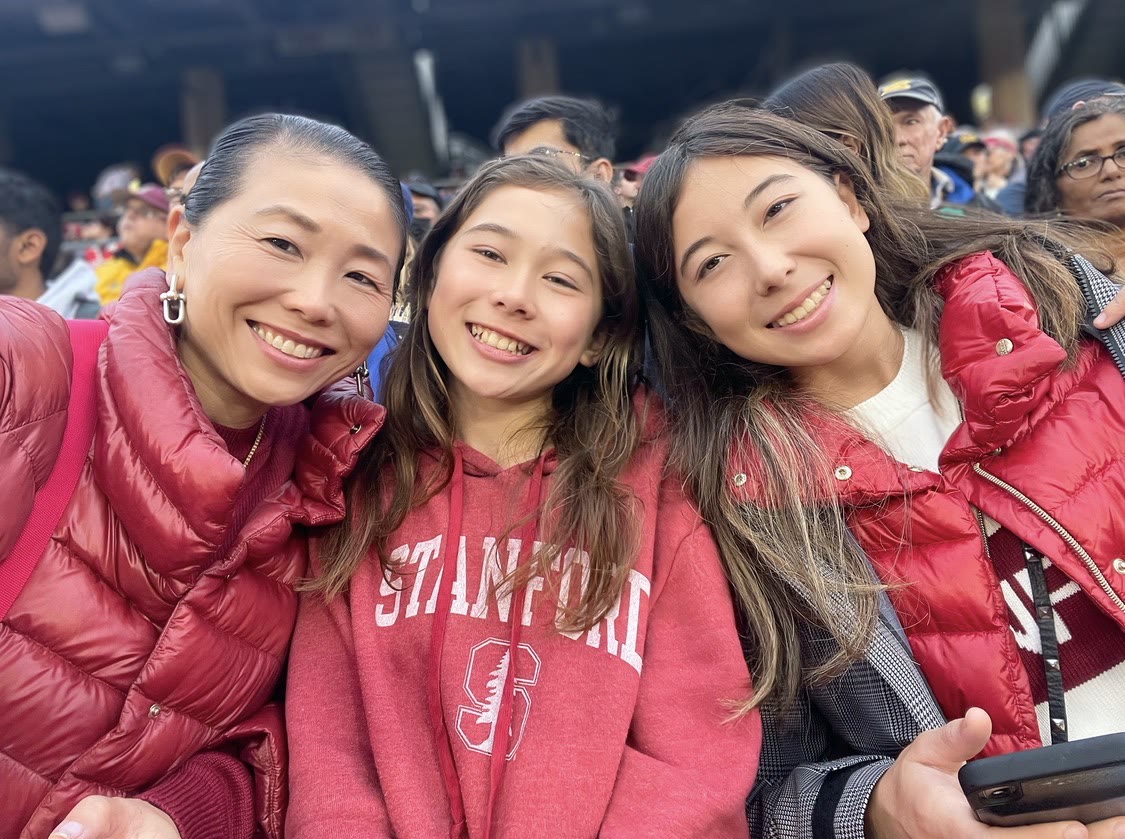 Dr. Shen Garnett with her daughters at a Stanford game