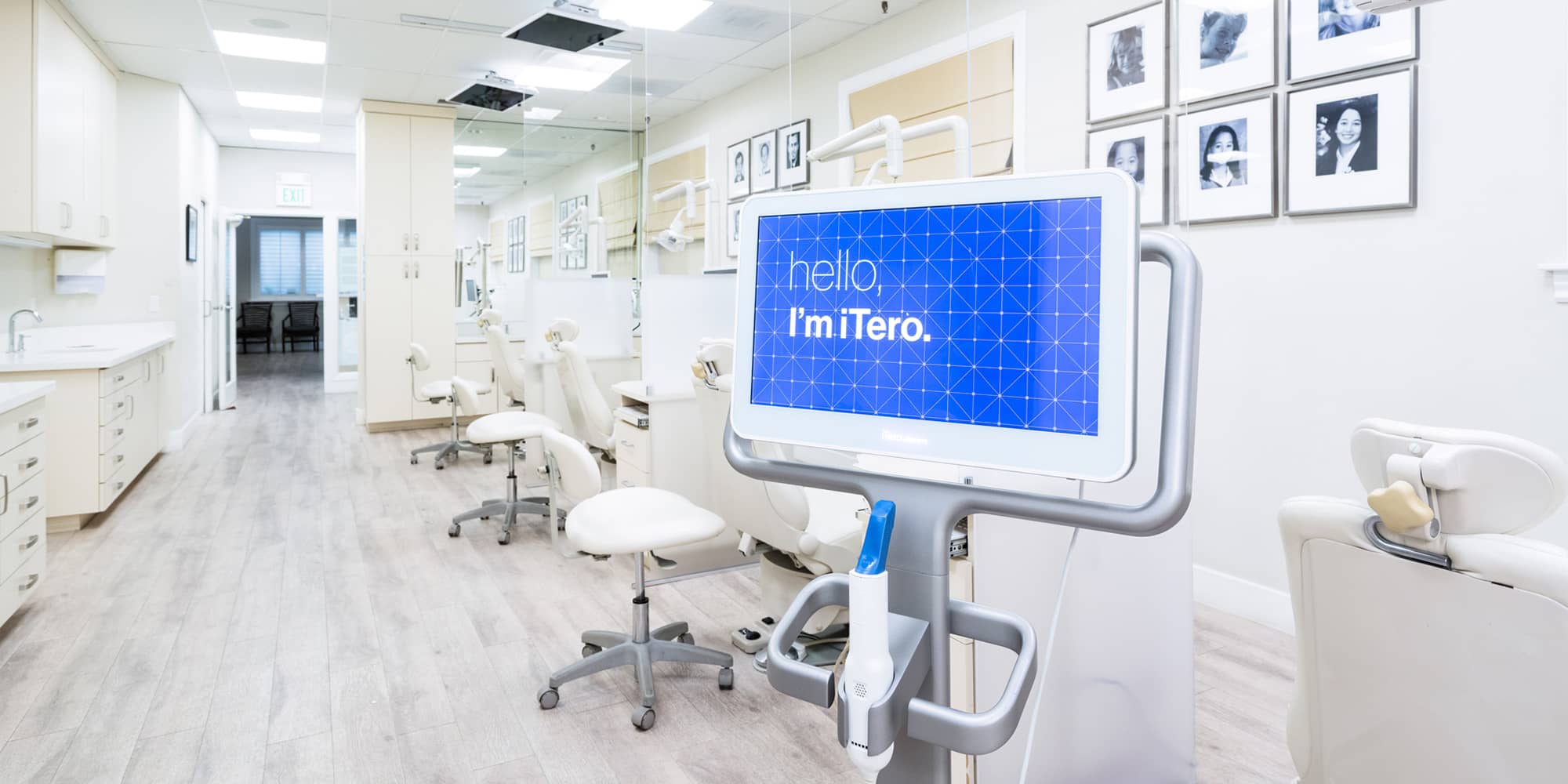An iTero scanner in the Bella Smile treatment bay, its screen reading hello, I'm iTero