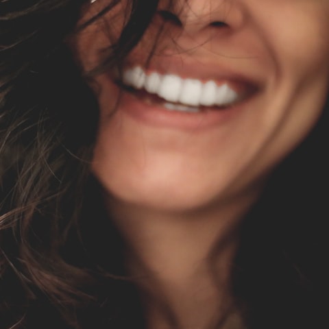 A person smiling after finishing orthodontic treatment