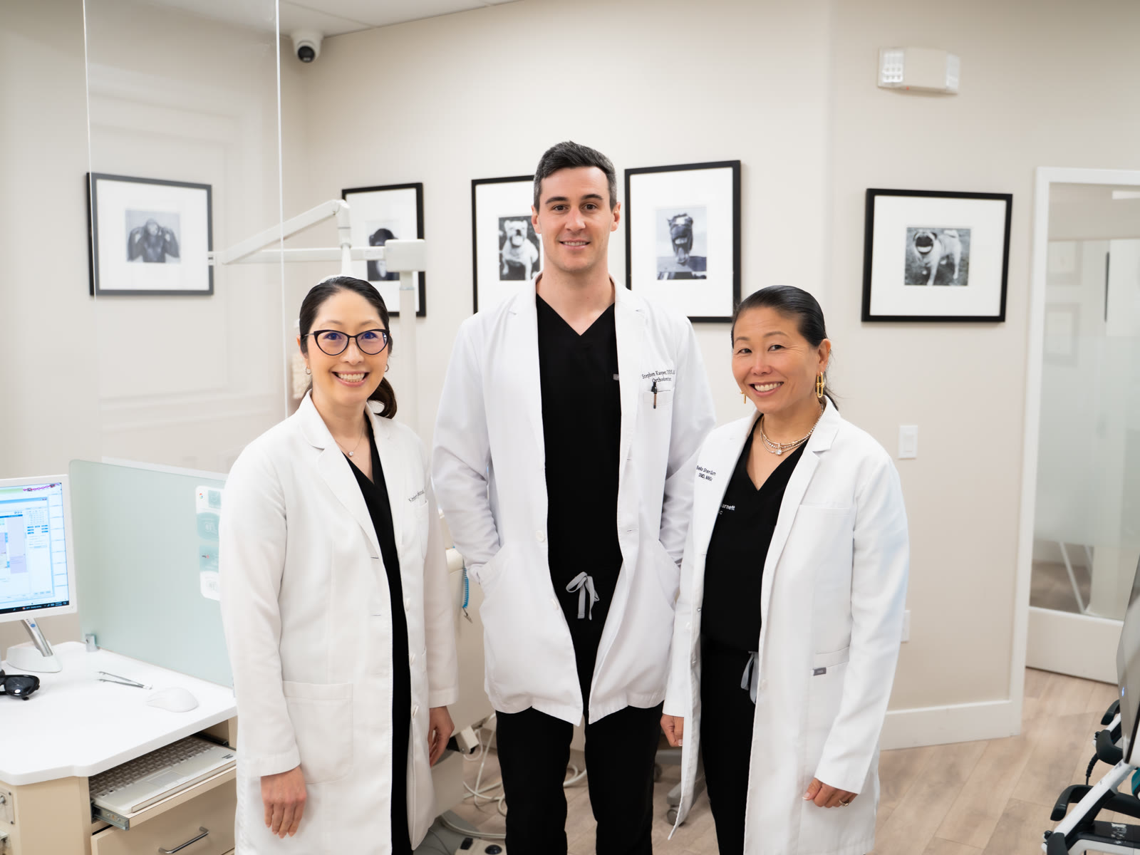 Drs. Mahood, Kasper and Shen Garnett in white coats in a Bella Smile treatment room